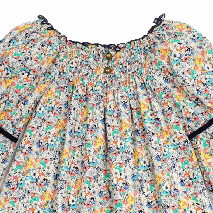 Blouse with smocked collar in blue, yellow and green floral liberty cotton, puffed sleeves, smocked collar from the children's fashion brand LA FAUTE A VOLTAIRE