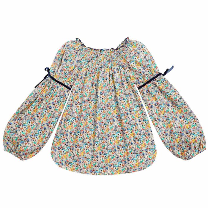 Blouse with smocked collar in blue, yellow and green floral liberty cotton, puffed sleeves, smocked collar from the children's fashion brand LA FAUTE A VOLTAIRE