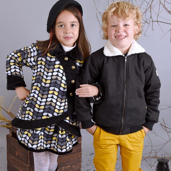 Offseason aviator jacket in black quilted cotton, with pockets, zippers and lining in beige faux fur imitation sheep for boys from 2 to 12 years old. La Faute à Voltaire, a French creative brand for children in fair trade.