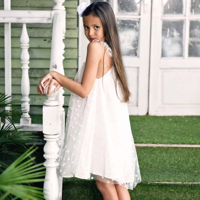 Bohemian off-white veil formal dress with square gold sequin collar, ruffled straps, cotton lining. Model Alizée from the children's fashion brand LA FAUTE A VOLTAIRE