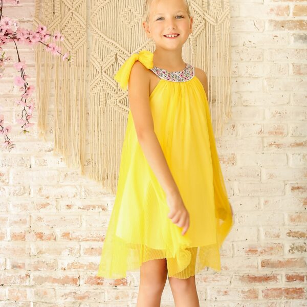 Pretty yellow veil dress and rounded collar in floral cotton lilac, yellow, bow on the shoulder. Dress for girls and teens from 2 to 16 years old from the French brand LA FAUTE A VOLTAIRE