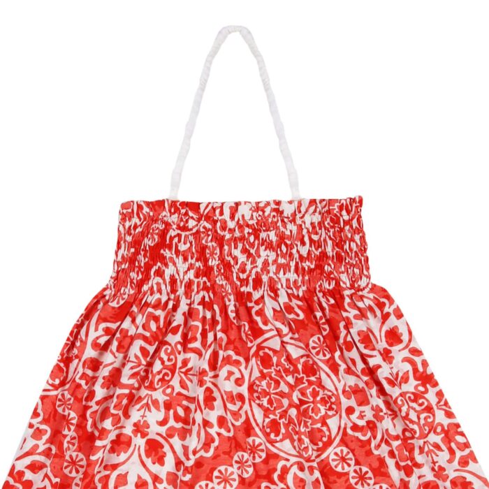 Long beach dress for girls in orange-red and beige cotton jersey, smocked collar, ruffles bordered with white, retractable strap. Two in one model with dress that turns into a skirt