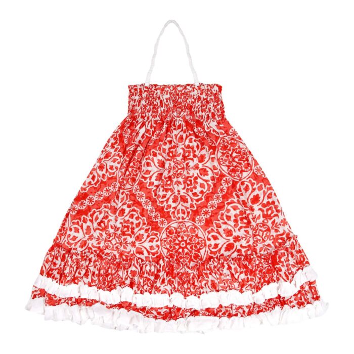 Long beach dress for girls in orange-red and beige cotton jersey, smocked collar, ruffles bordered with white, retractable strap. Two in one model with dress that turns into a skirt