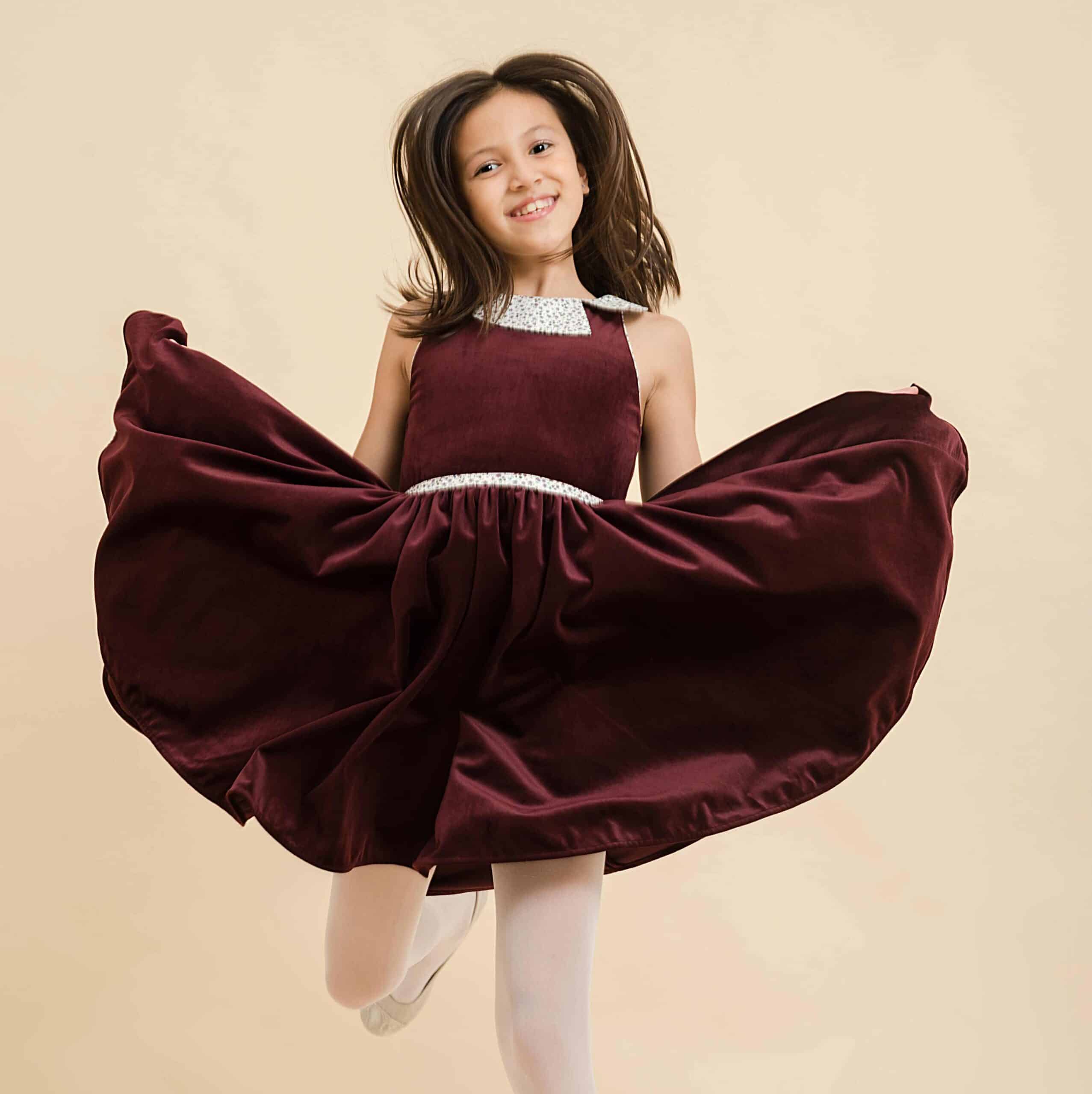 Turning dress for girls in burgundy velvet and small purple flowers collar from the children's fashion brand la faute a voltaire