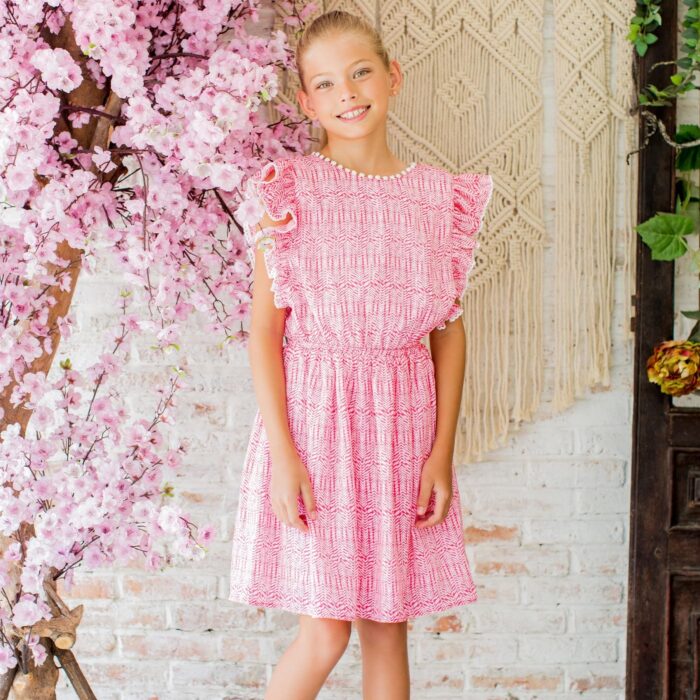 Short sleeve summer dress with ruffles in pink and white printed cotton, elastic waist, knee length. Elegant V-neck back dress perfect for ceremonies from the children's fashion brand LA FAUTE A VOLTAIRE