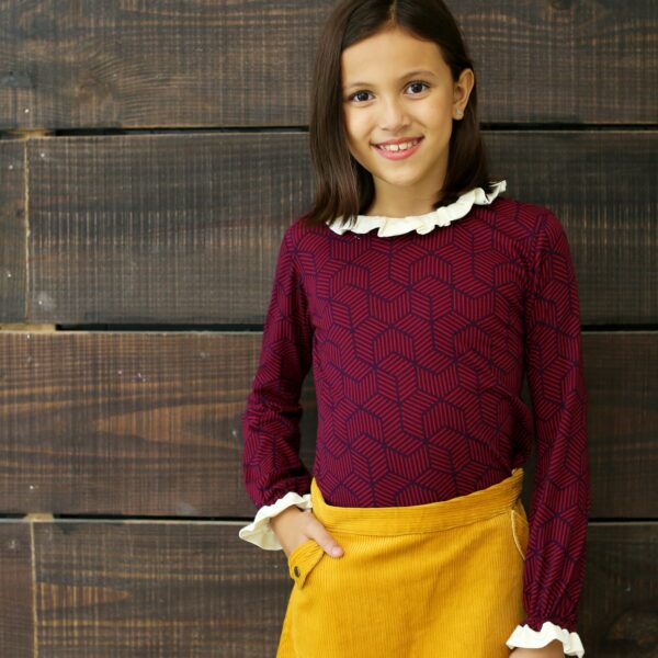 Plum colored cotton jersey long sleeve tee with navy blue geometric pattern, white frilly collar and sleeves. Retro-chic girls' fashion from 2 to 14 years old from the French fair trade children's brand LA FAUTE A VOLTAIRE