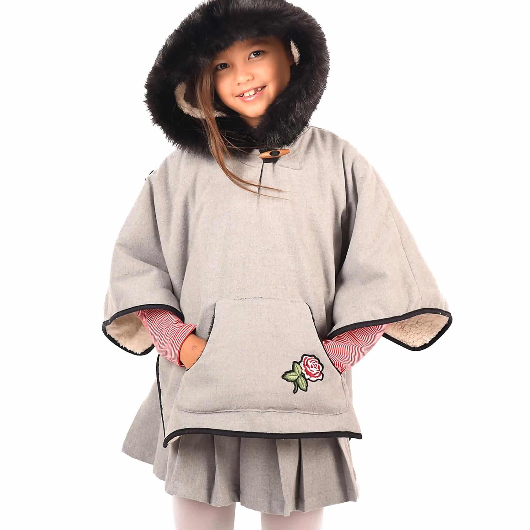 Grey wool poncho cape with big hood lined with beige faux fur and surrounded by black faux fur for girls from the children's fashion brand LA FAUTE A VOLTAIRE