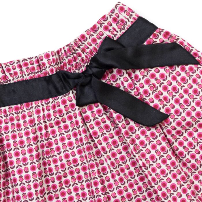 pretty pink floral skirt for girls with elastic waist and black satin ribbon. Chic and comfortable skirt for girls from the children's fashion brand la faute a voltaire