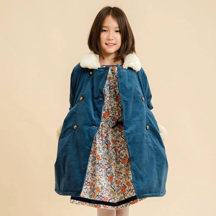 Velvet coat. blue green duck millerais with beige faux fur collar for girls and young women from the children's fashion brand LA FAUTE A VOLTAIRE