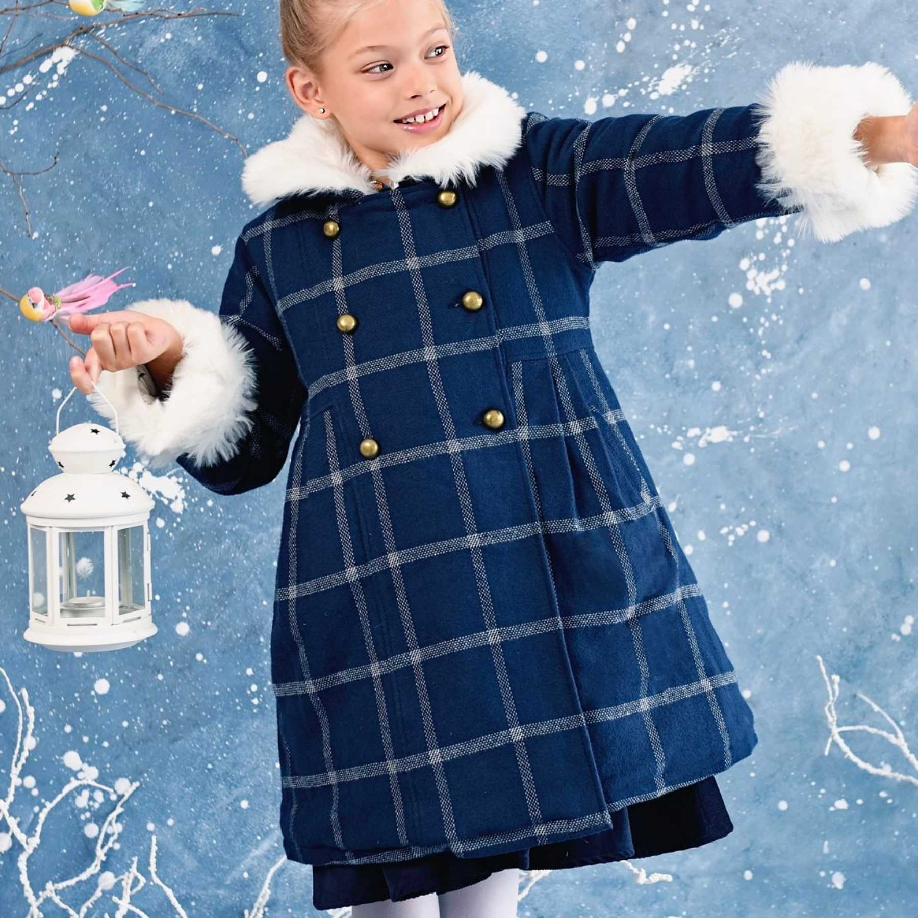 Navy blue wool coat with large white checks and white faux fur collar for girls from the children's fashion brand LA FAUTE A VOLTAIRE