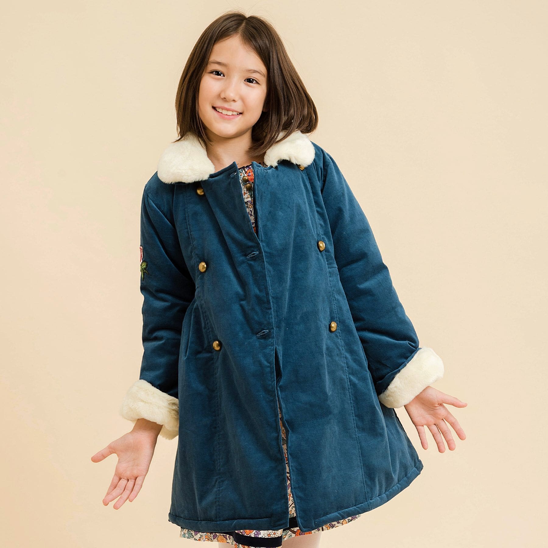 Velvet coat. blue green duck millerais with beige faux fur collar for girls and young women from the children's fashion brand LA FAUTE A VOLTAIRE