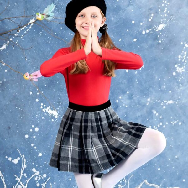 Retro chic fashion for kids with grey tartan plaid pleated skirt and red contrasting undershirt from the French children's fashion brand LA FAUTE A VOLTAIRE