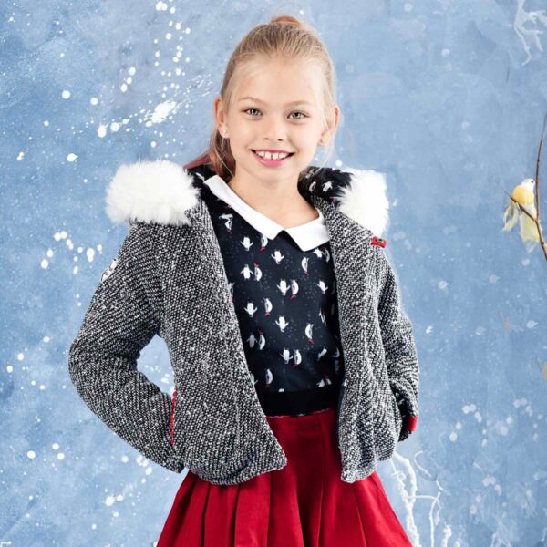 Black and white tweed wool short inter-season jacket with white faux fur trimmed hood, pockets and red detail trimmed closure. Fair trade brand for children LA FAUTE A VOLTAIRE