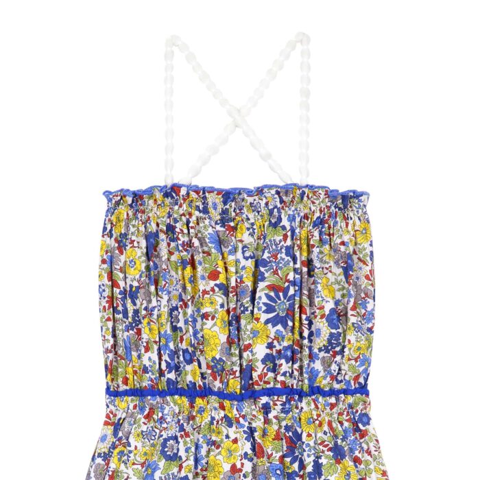 Cute yellow and blue cotton liberty jumpsuit for girls, with smocked collar and elastic waist, elastic straps with white tassels. Summer model of the children's fashion brand LA FAUTE A VOLTAIRE