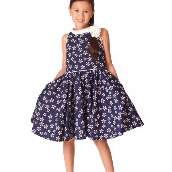 Pretty navy blue ceremonial dress with white and red flowers, beige satin collar turned upside down, sleeveless. Dress of the fashion brand of clothing for children and teenagers LA FAUTE A VOLTAIRE
