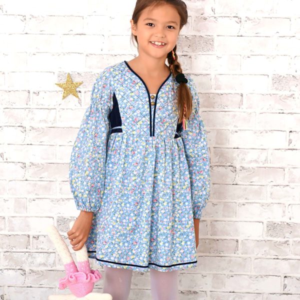 Winter dress girl bi-material in blue sky floral cotton liberty pink and yellow with navy blue velvet, quilted front plastron and navy blue ribbon for girls from 2 to 14 years old. La Faute à Voltaire, a French brand for children in fair trade.