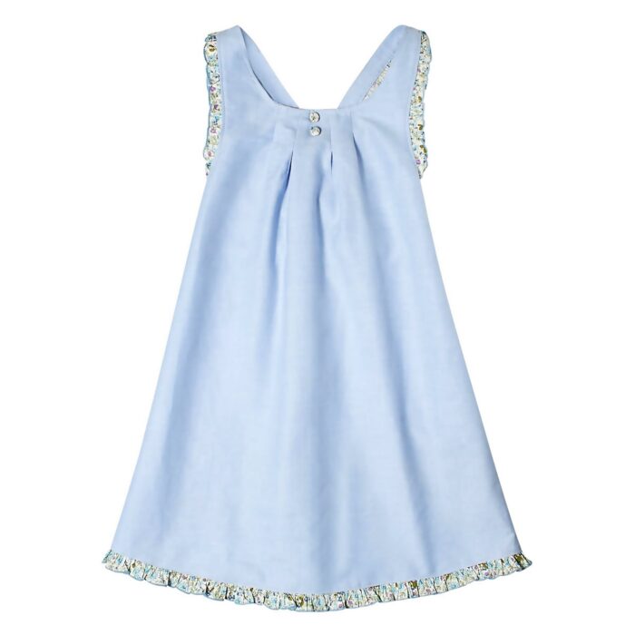 Girl's sky blue summer dress with ruffled straps and contrasting back in blue, green, lilac floral cotton. ANAIS apron dress model from the children's fashion brand LA FAUTE A VOLTAIRE