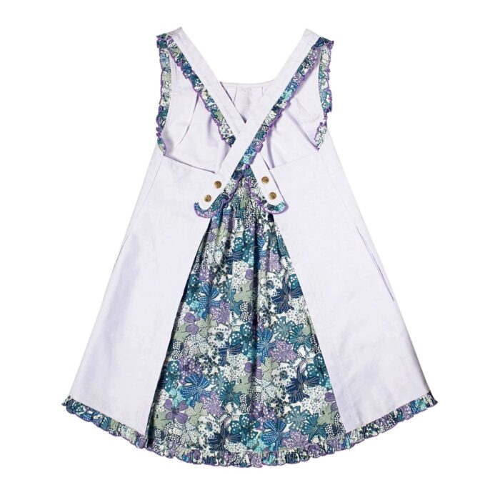 Girl's lilac summer dress with ruffled straps and contrasting back in navy, purple, lilac floral cotton. ANAIS apron dress model from the children's fashion brand LA FAUTE A VOLTAIRE