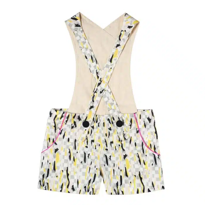short salopette coton imprimé blanc, gris, jaune avec biais rose fuchsia et gros bouton décoratif noir. Dos amovible avec boutons intérieur. Shorts salopette pour filles et. fillettes de la marque de mode pour enfants LA FAUTE A VOLTAIRE