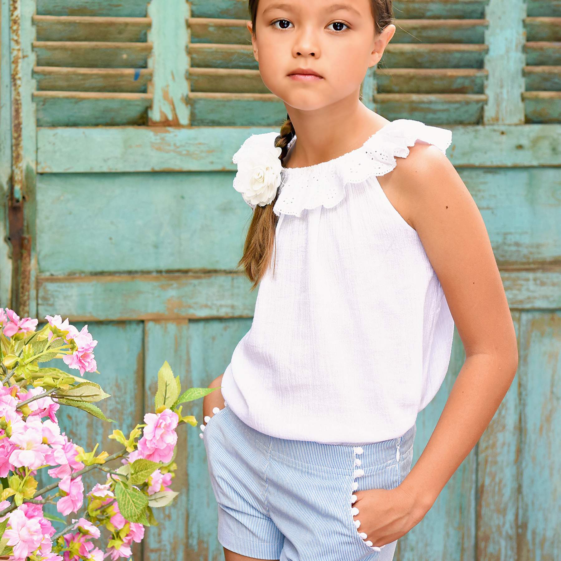 Summer shorts with dark blue and white stripes girl cotton with. white tassels on the pockets and pocket. Elegant and trendy shorts for girls from the children's fashion brand LA FAUTE A VOLTAIRE