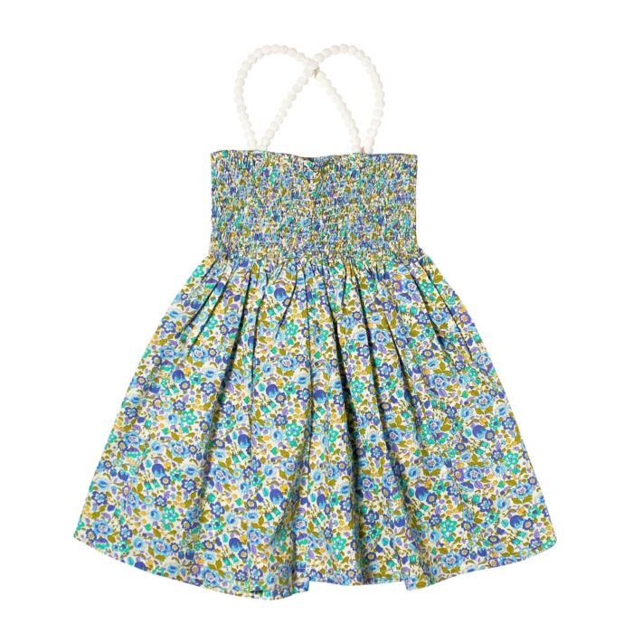 Romantic blouse in blue, yellow and green liberty cotton flowers, with smocks, white stretchy pompom straps from the children's fashion brand LA FAUTE A VOLTAIRE