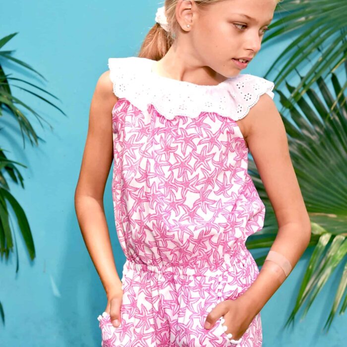 Cute fuchsia pink and white starfish combishort for girls from 2 to 12 years old with a white embroidery anglaise collar and pockets lined with white pompons from the children's fashion brand LA FAUTE A VOLTAIRE