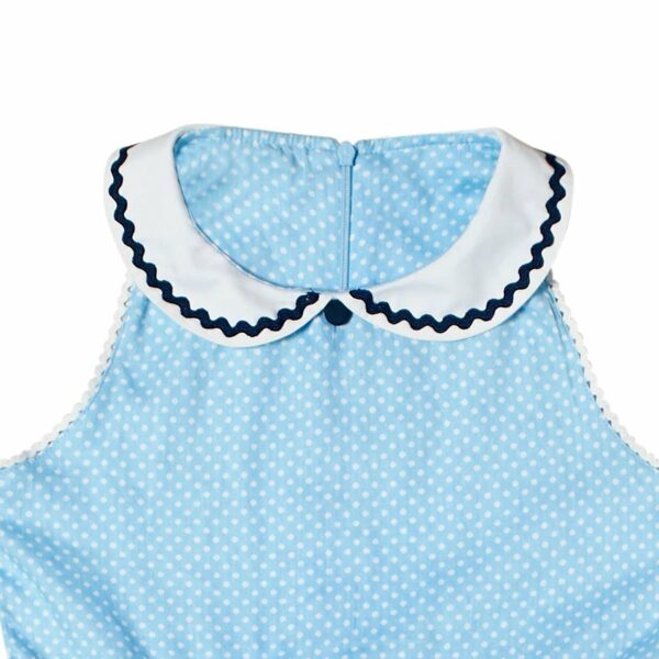 Adorable girls' formal dress that turns horizontally in light blue cotton with white polka dots, Claudine collar and fitted white belt with navy blue zigzag band. Procession dress of the fashion brand for children and teenagers LA FAUTE A VOLTAIRE
