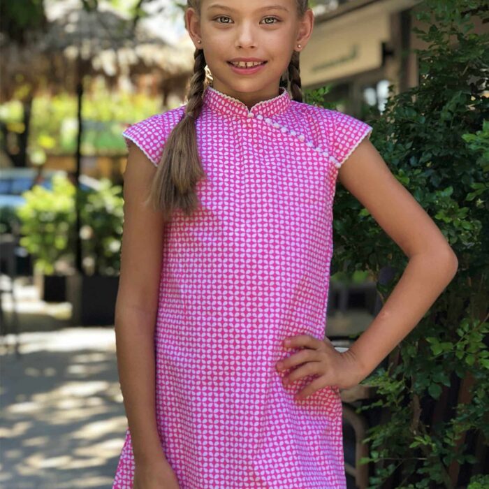 Fuchsia pink and white cotton graphic summer dress with Mao collar and short sleeves trimmed with tassels for girls from 2 to 14 years