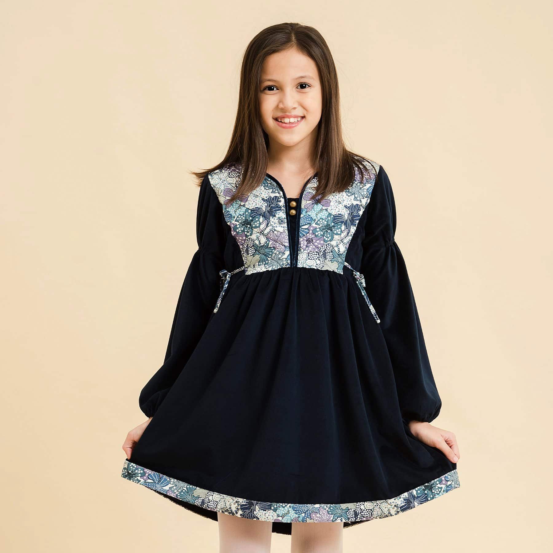 Navy blue winter dress for girls with long balloon sleeves and sky blue liberty flowers from the children's fashion brand LA FAUTE A VOLTAIRE