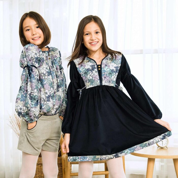 Navy blue winter dress for girls with long balloon sleeves and sky blue liberty flowers from the children's fashion brand LA FAUTE A VOLTAIRE