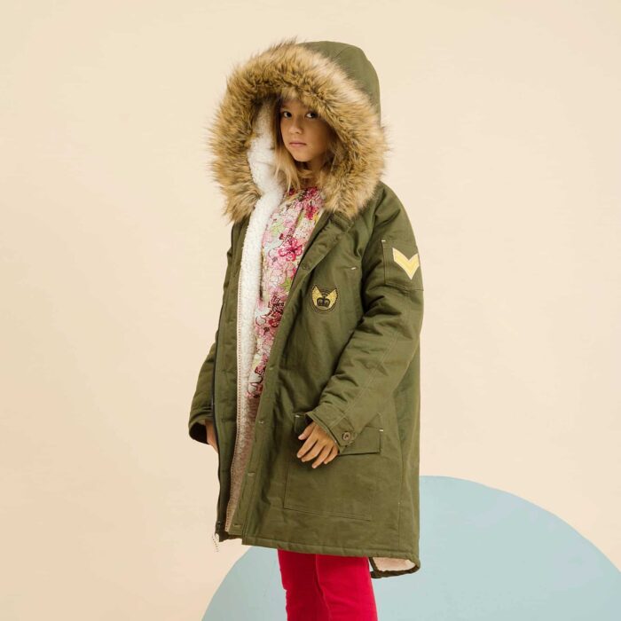 Long and warm parka for teenage girl and woman in khaki cotton lined with beige fake fur, hood lined with fake fur imitation fox, vintage poster for animal protection in the back of the fashion brand in fair trade LA FAUTE A VOLTAIRE