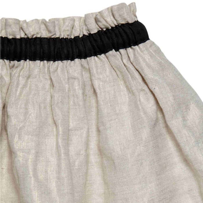 Beige linen formal skirt for little girl, elastic waistband with black contrasted satin, from the children fashion brand LA FAUTE A VOLTAIRE