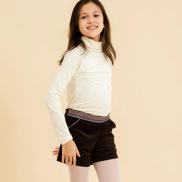 Short winter girl in brown velvet and integrated belt with multicolored sequins pink, gold, blue and purple. Adjustable waist with elastic in the back, pockets highlighted with a pink sequin bias, side opening with zipper and snap. LA FAUTE A VOLTAIRE, fair trade children's clothing brand