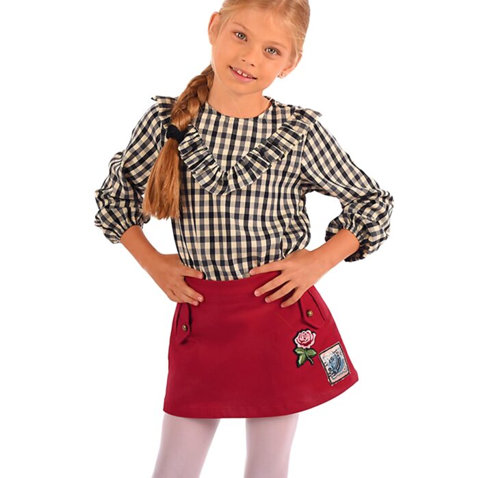 short burgundy jean skirt, adjustable waist, with a pink flower patch on the front. Children's fashion clothing from the French fair trade brand LA FAUTE A VOLTAIRE
