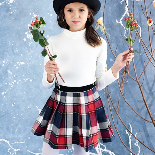 Scottish skirt in woolen tartan tiles navy blue red for girls and teens from 2 to 16 years old, with integrated belt in black velvet and contrasting golden bias. Side closure with snap and zipper. French brand creator of LA FAUTE A VOLTAIRE