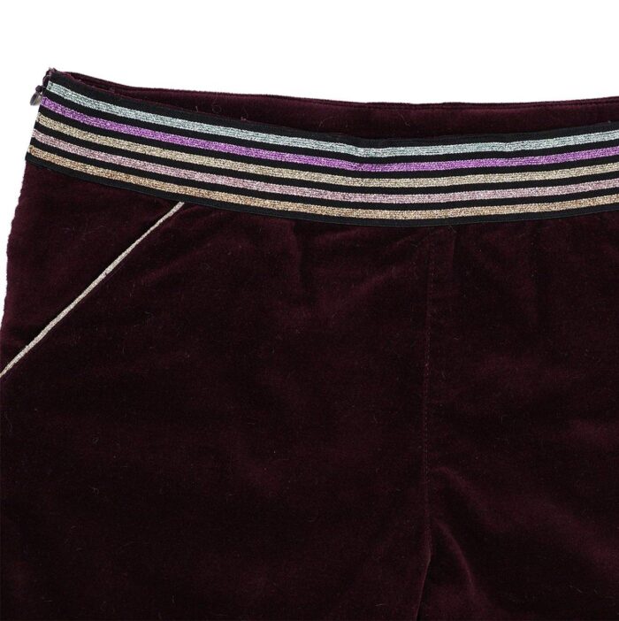 Short winter girl velvet burgundy, plum and integrated belt with multicolored sequins pink, gold, blue and purple. Adjustable waist with elastic in the back, pockets highlighted with a pink sequin bias, side opening with zipper and snap. LA FAUTE A VOLTAIRE, fair trade children's clothing brand