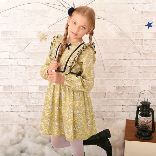 Yellow and light blue floral liberty dress, ruffles on armholes, long sleeves with elastic cuffs and navy blue details. Children's fashion brand LA FAUTE A VOLTAIRE