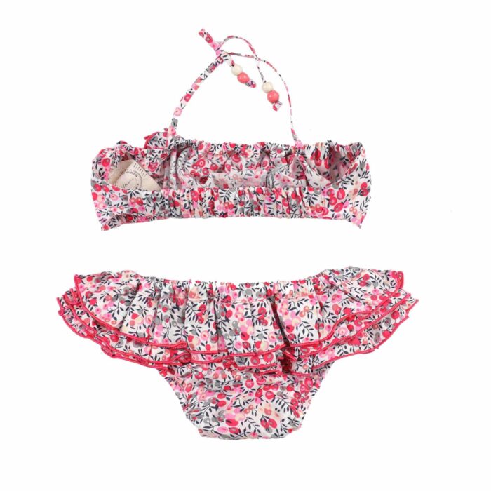 Cute two-piece swimsuit with ruffles for little girls and teens from 2 to 16 years old, in fuchsia pink and light pink floral cotton. Beach bikini from the fashion brand for children and teenagers LA FAUTE A VOLTAIRE