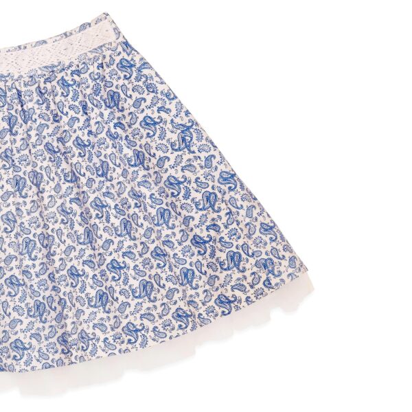 Nice summer skirt in white cotton, with blue paisley patterns. With lace details, and white tulle for girls. Skirt of the fashion brand for children and teenagers LA FAUTE A VOLTAIRE.