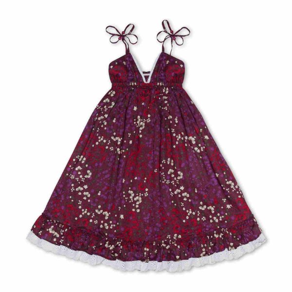 Pretty dress that turns in floral burgundy cotton, with thin straps, white lace and ruffles. Dress of the fashion brand for children and teenagers LA FAUTE A VOLTAIRE.