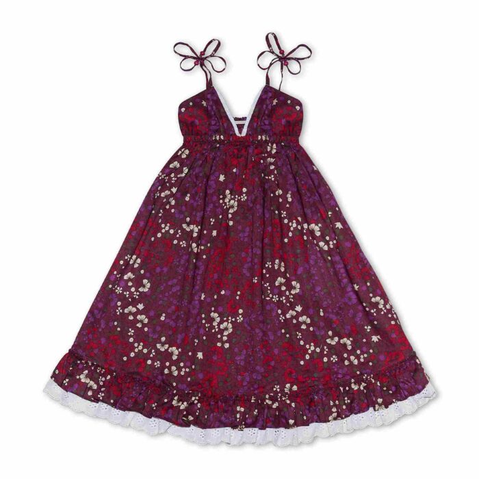 Pretty dress that turns in burgundy cotton flowered, with thin straps, white lace and ruffles. Dress from the fashion brand for children and teenagers LA FAUTE A VOLTAIRE.