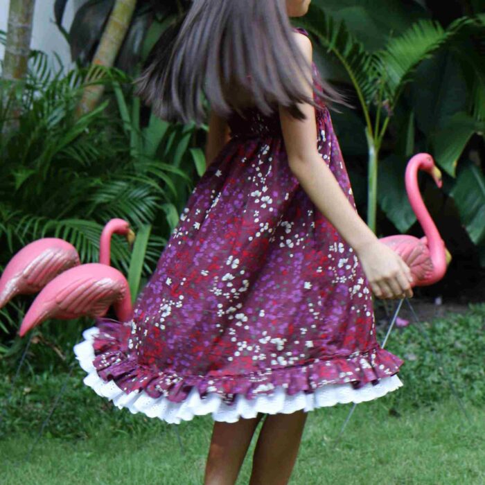 Pretty dress that turns in burgundy cotton flowered, with thin straps, white lace and ruffles. Dress from the fashion brand for children and teenagers LA FAUTE A VOLTAIRE.