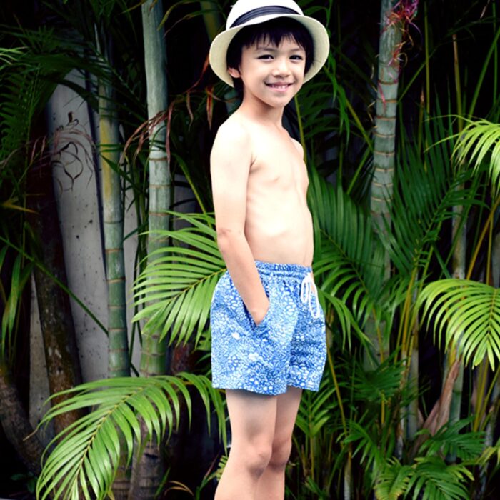 Cute swim shorts for boy in royal blue cotton printed fish, anchor, white shark. Elastic belt with decorative white cord. Mesh panties inside. Beach fashion clothes for children from 2 to 16 years old LA FAUTE A VOLTAIRE