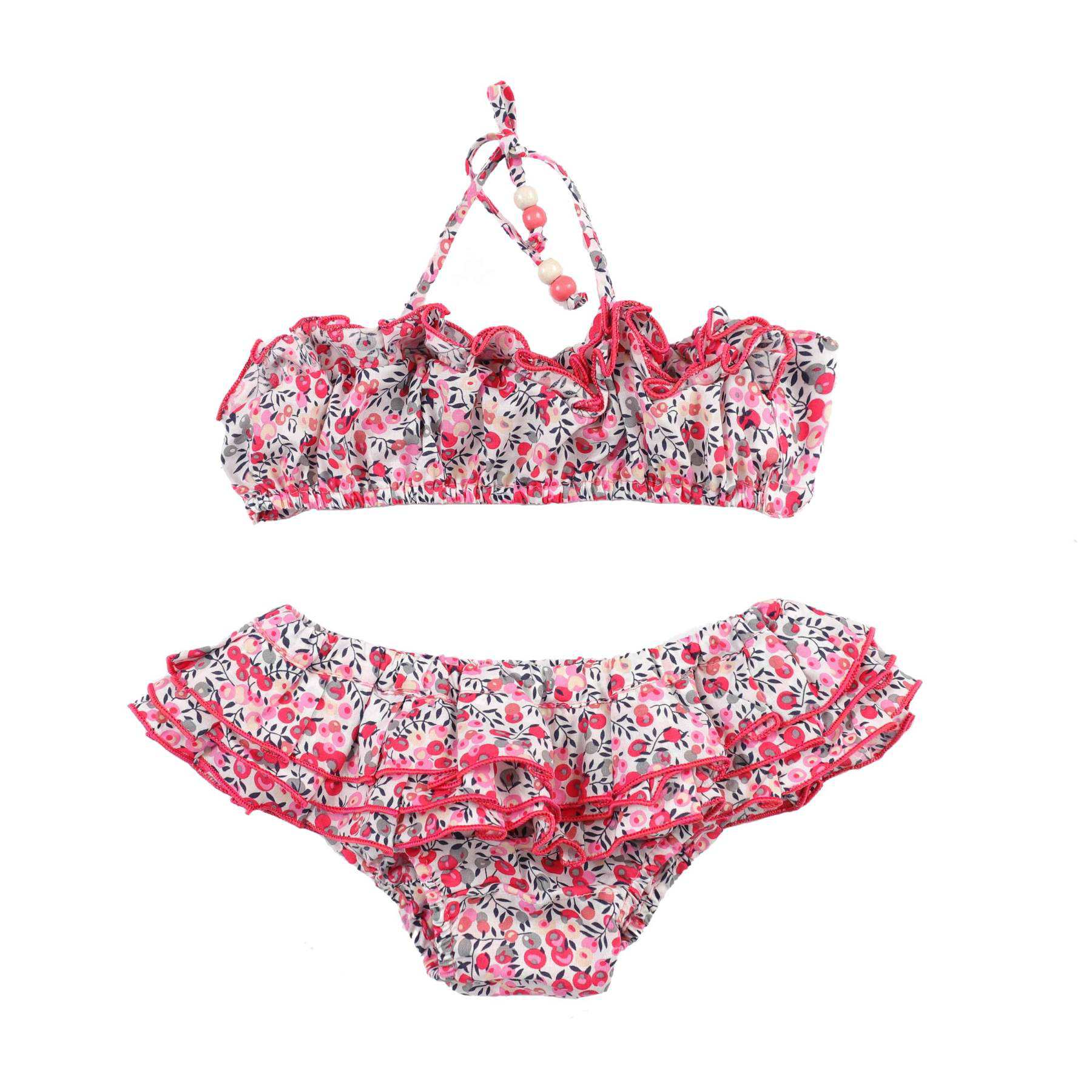 Photo packshot du maillot de bain deux pièces liberty rose fille avec double rangées de volants sur le bandeau, élastique dans le dos, lien tour du cou pour la fermeture. Culotte avec double rangées du volants surpiqué de rose soutenu.