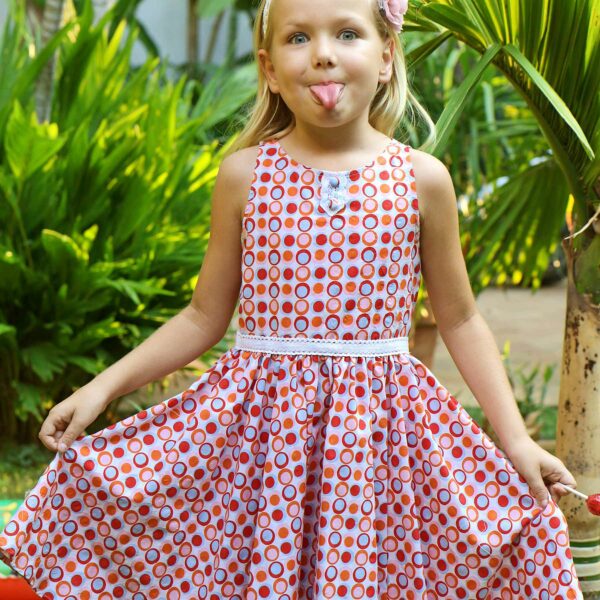 Cute summer dress in cotton with red, pink and blue circles for girls. Dress model HEPBURN of the fashion brand for children and teenagers LA FAUTE A VOLTAIRE.