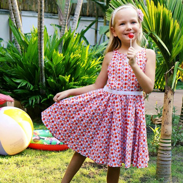 Pretty summer dress in cotton with red, pink, sky blue circles for girls. HePBURN dress model from the fashion brand for children and teenagers LA FAUTE A VOLTAIRE.
