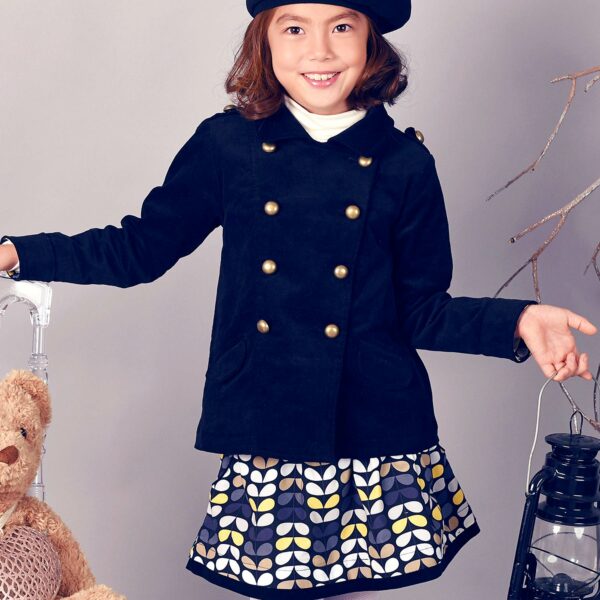 Pretty cotton skirt for girls with yellow and blue patterns, lined with pockets in navy blue velvet and elasticated velvet belt. Lilou skirt model from the fashion brand for children and teenagers LA FAUTE A VOLTAIRE.