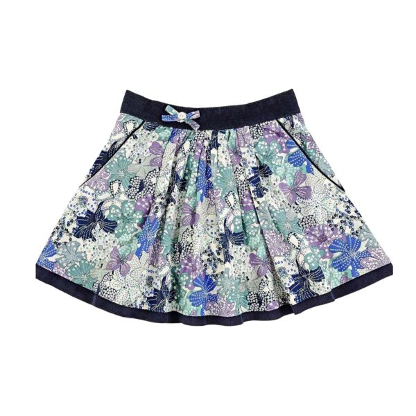 Pretty skirt for girls in blue floral liberty cotton, lined with black velvet pockets and elasticated velvet belt. Lilou skirt model from the fashion brand for children and teenagers LA FAUTE A VOLTAIRE.