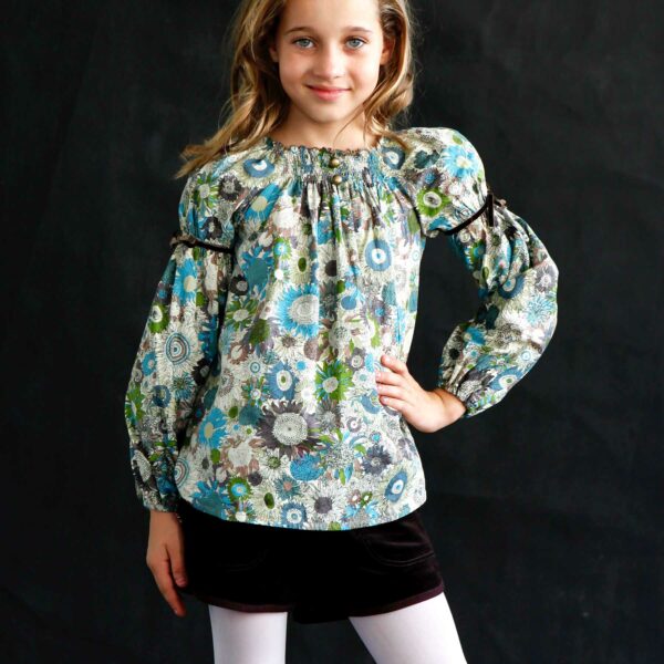 Blouse for girl from 2 to 16 years old in brown, beige, blue and green liberty cotton, with balloon sleeves and smocks collar from the fair trade fashion brand for children LA FAUTE A VOLTAIRE