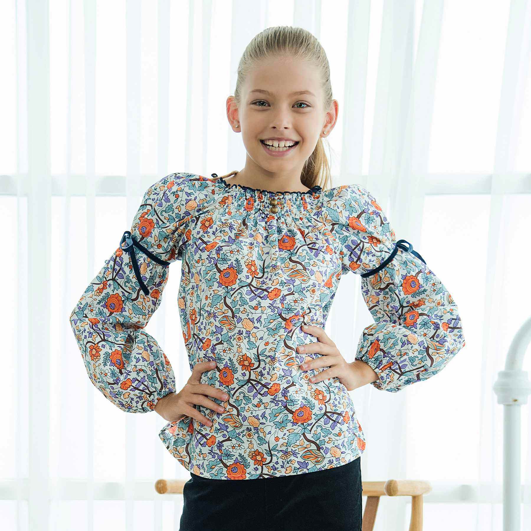 Pretty flowered blouse for girls and girls in cotton flowers liberty orange, lilac, green. Blouse with smocked collar and balloon sleeves from the children's fashion brand LA FAUTE A VOLTAIRE